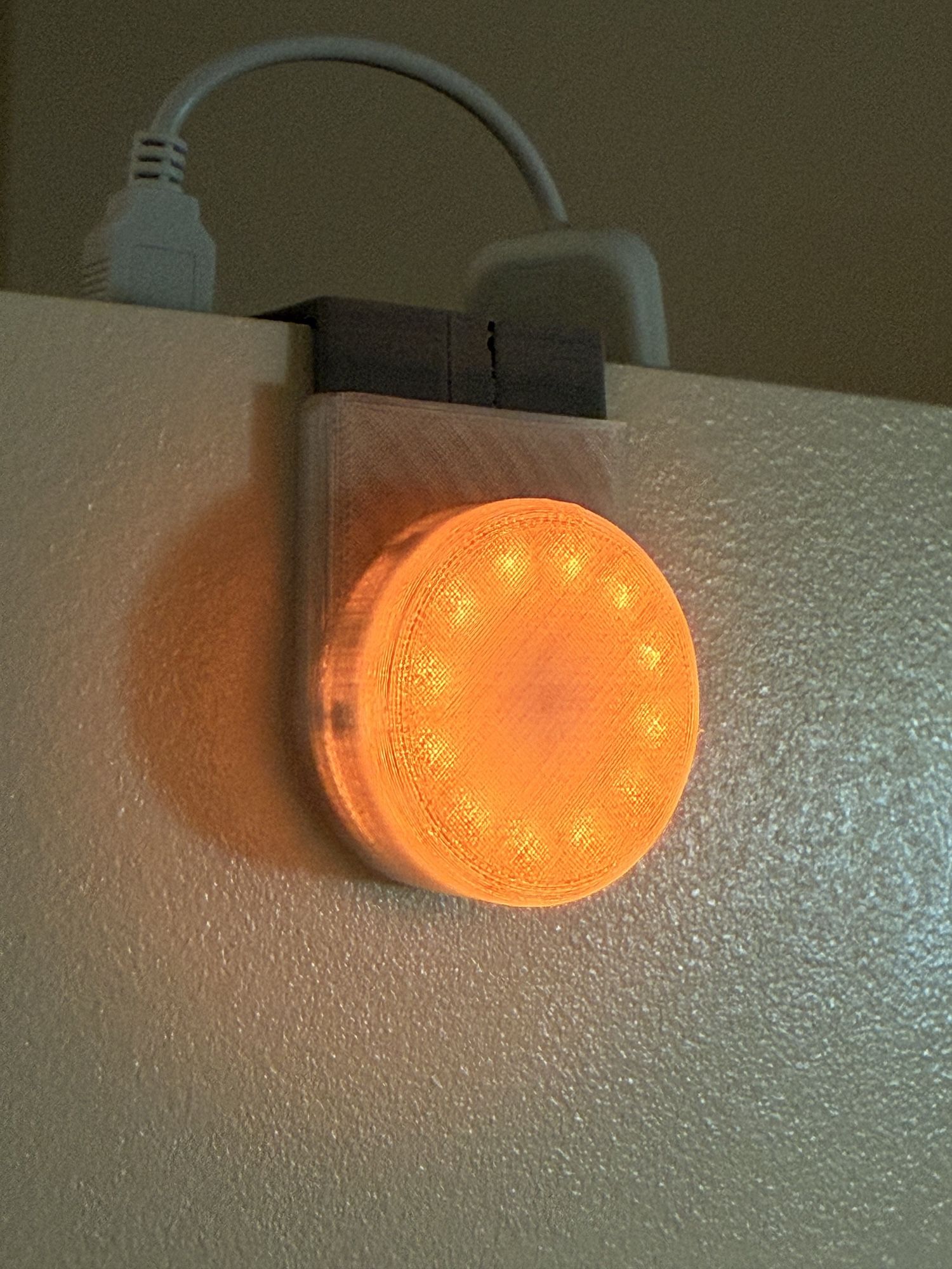 The Busy Light hardware: an LED ring in a 3D-printed enclosure mounted on a door frame